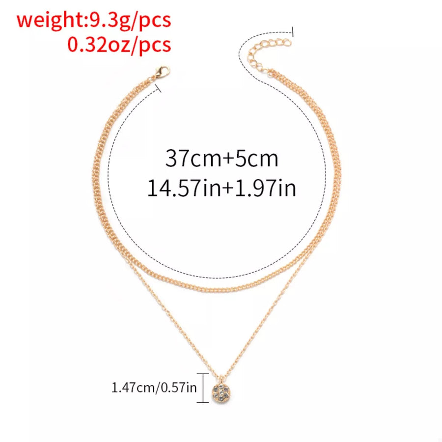Gold double layered pendant necklace with small crystal charm.