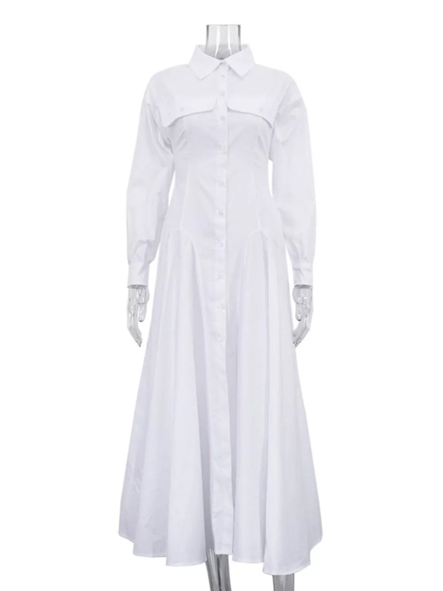 White cotton shirt dress with long sleeves, pointed collar, button front, and full skirt.