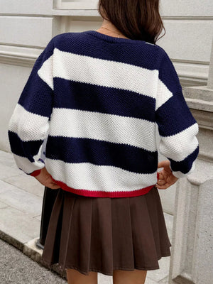 Casual ribbed knit sweater with navy and white stripes, crew neck, and red trim.