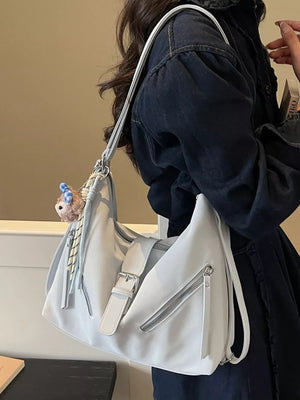 Light blue distressed leather shoulder bag with buckle and diagonal zippers