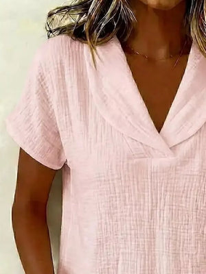 Lotus Color textured blouse with short sleeves and a V-neck collar.