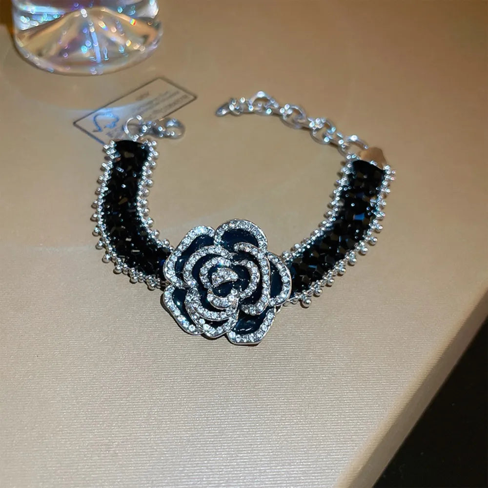 Black bracelet with rose petal embellishment and crystal details