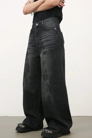 Oversized charcoal wash denim jeans with a wide leg and distressed details.