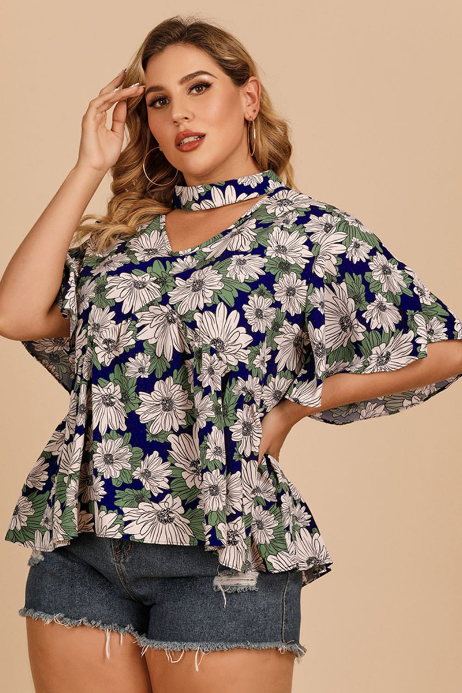 Dark blue floral peplum blouse with keyhole neckline and flutter sleeves.