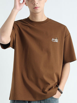 Men's brown cotton t-shirt with round neck and graphic chest print.