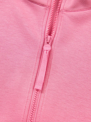 Dusty pink zip-up hoodie detail with textured zipper pull and fabric.