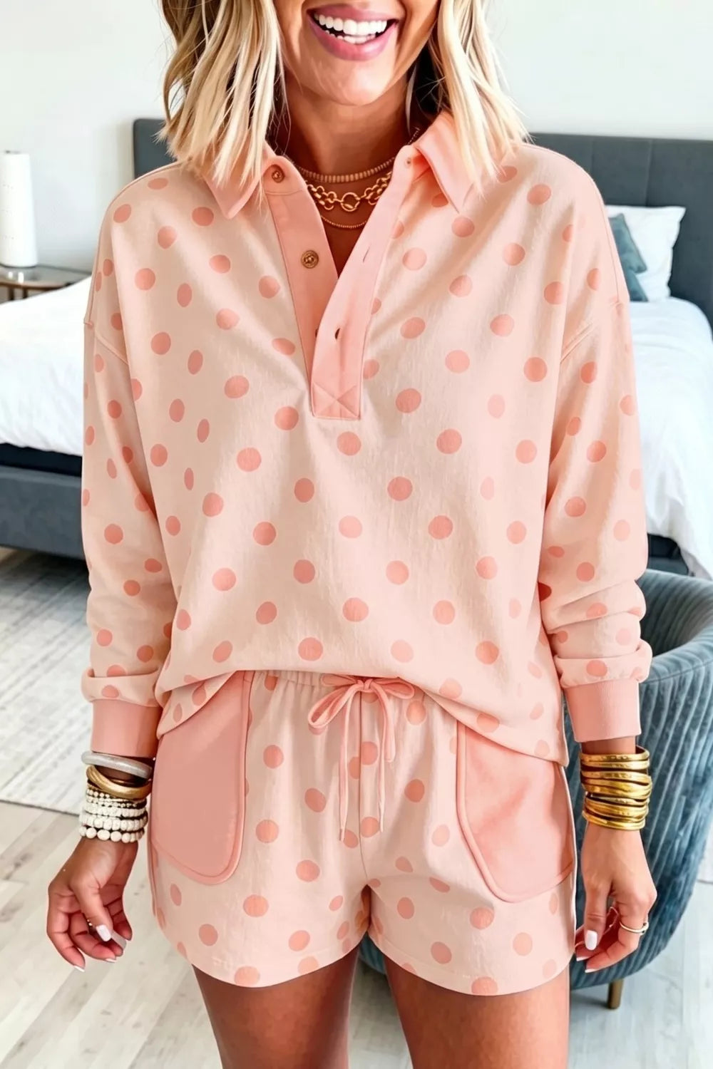 Pink polka dot lounge set with collared pullover and drawstring shorts.