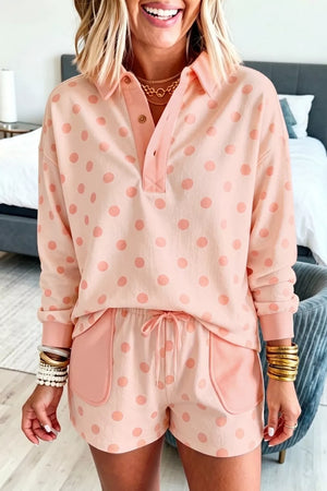 Pink polka dot lounge set with collared pullover and drawstring shorts.