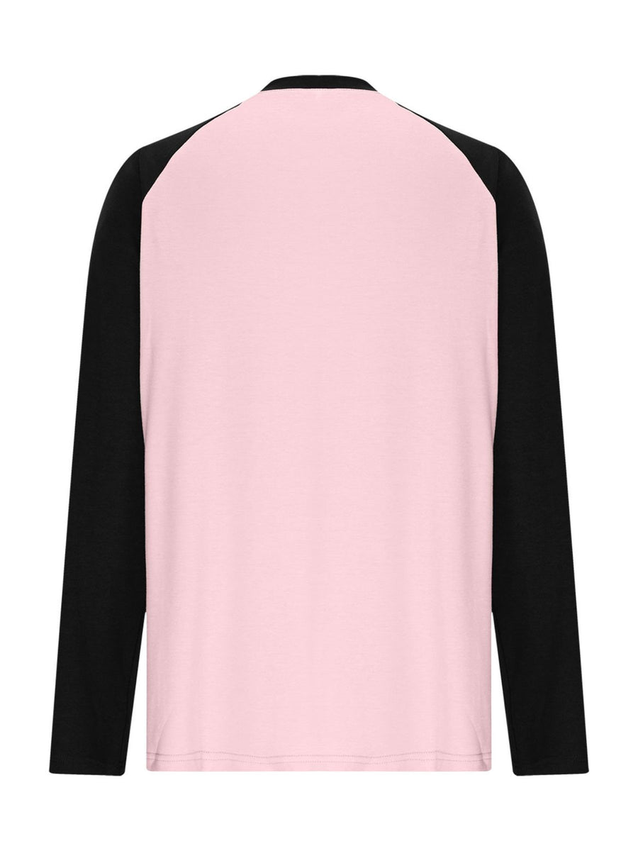 Blush pink long sleeve t-shirt with black raglan sleeves and round neck.