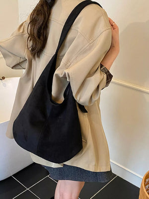 Large black suede hobo shoulder bag with a single strap.