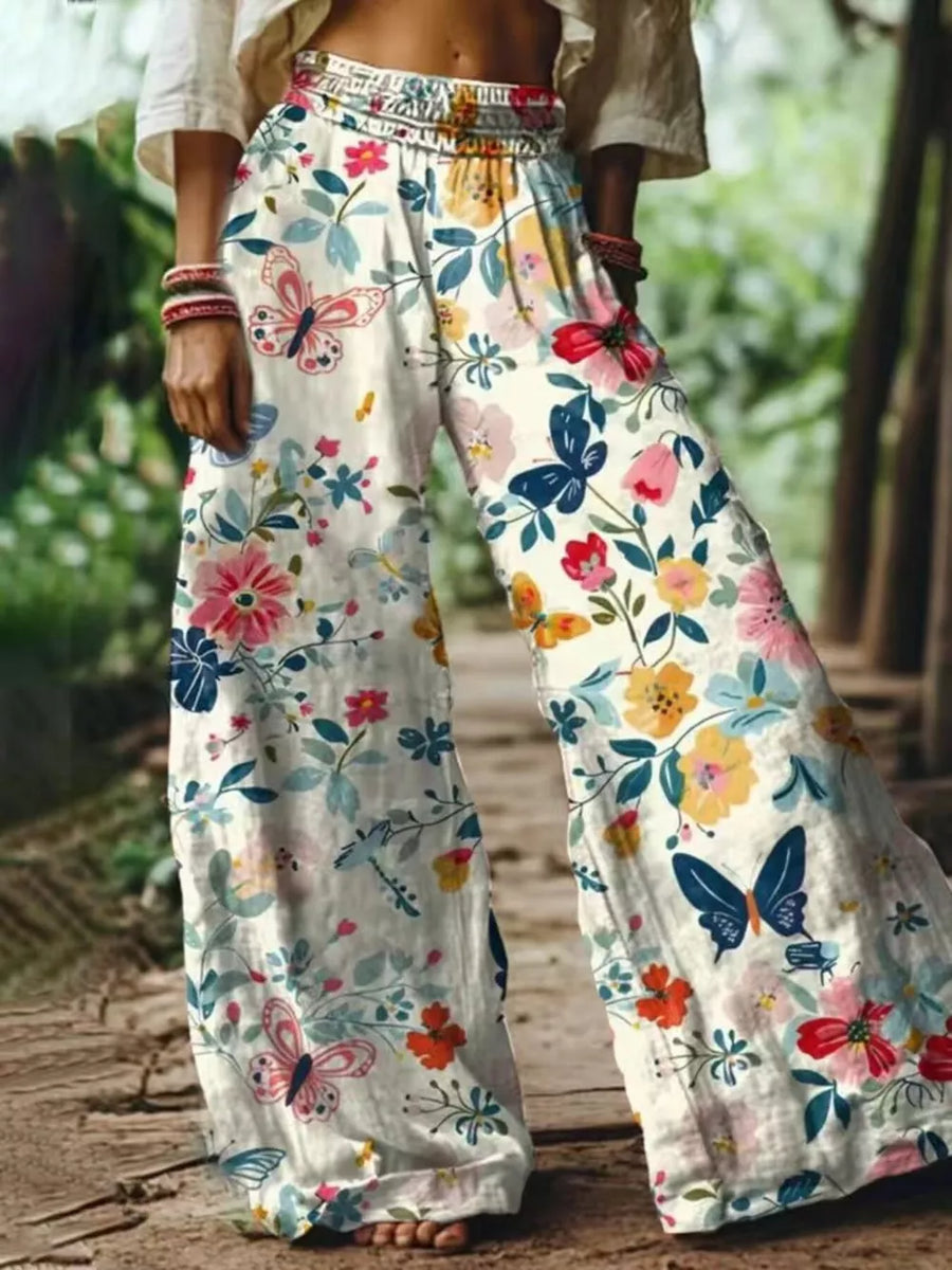 wide-leg pants in cream featuring elastic waist and flared fit