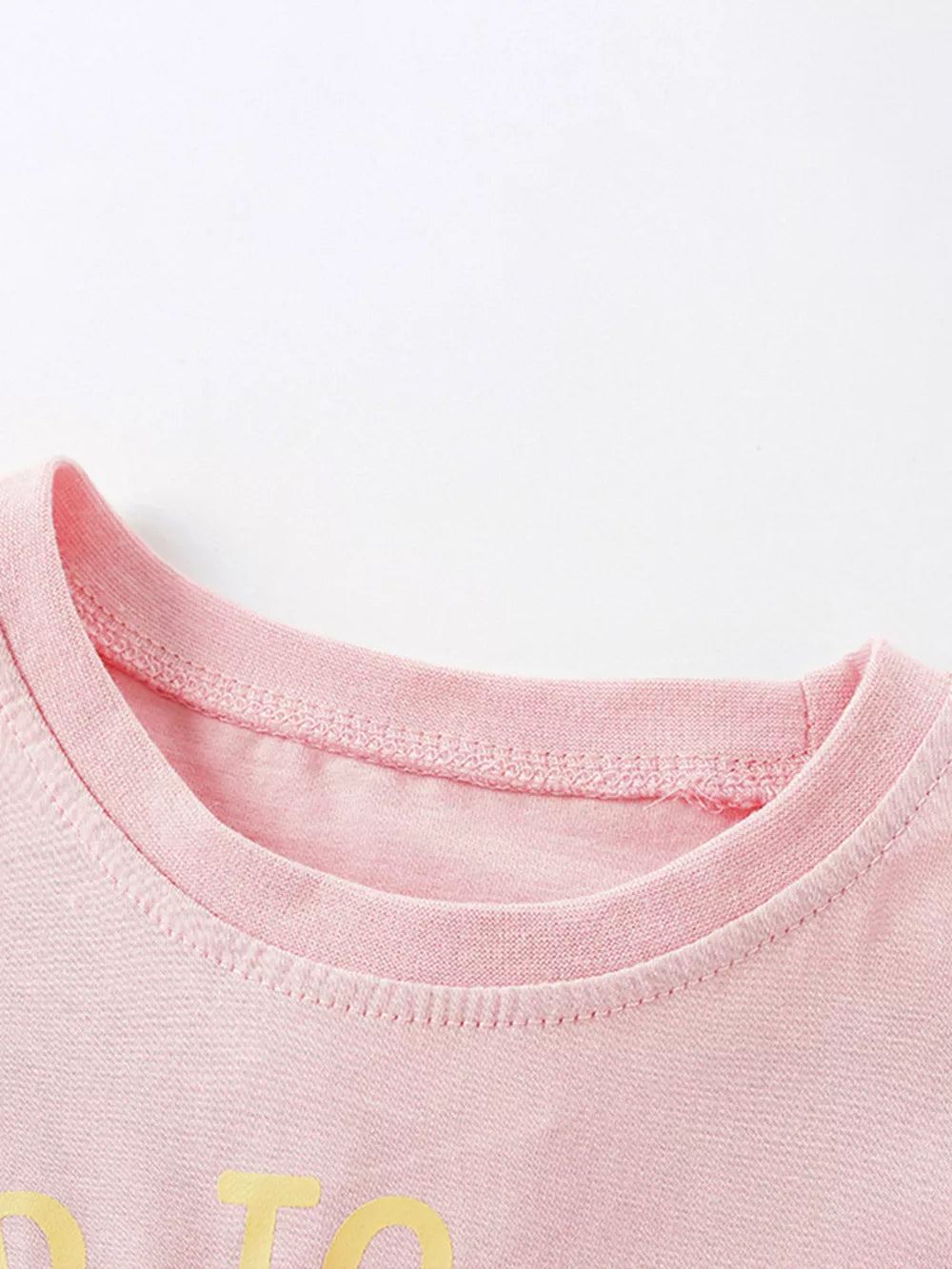 Toddler pink cotton t-shirt with crew neck and yellow graphic detail.