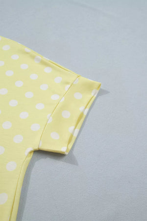 Pastel yellow polka dot polyester top with short sleeves and a crew neck.