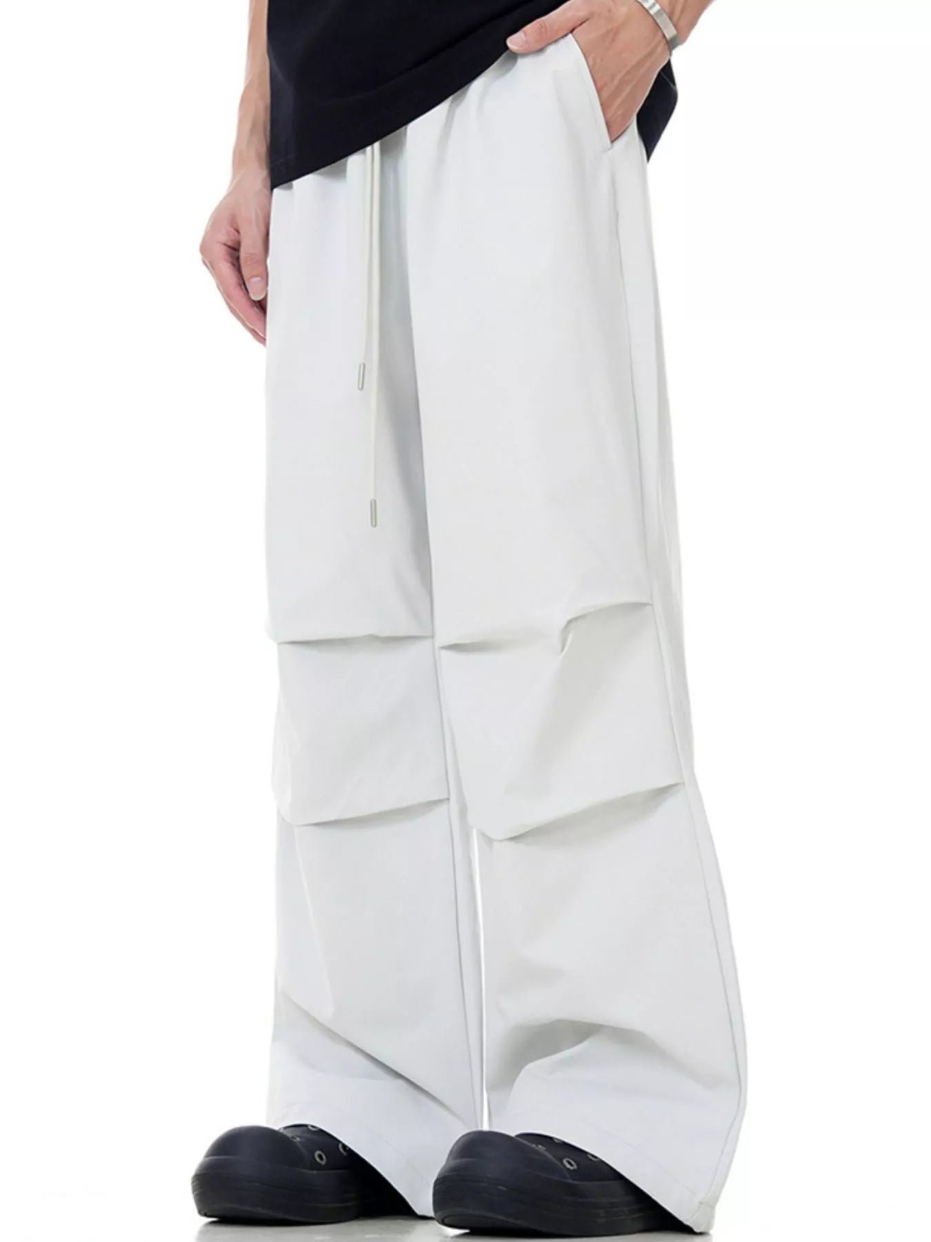 Men's beige wide-leg drawstring jogger pants with layered cargo pockets.
