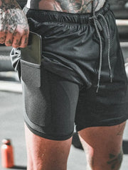 Black dual-layer performance shorts with phone pocket and drawstring waist