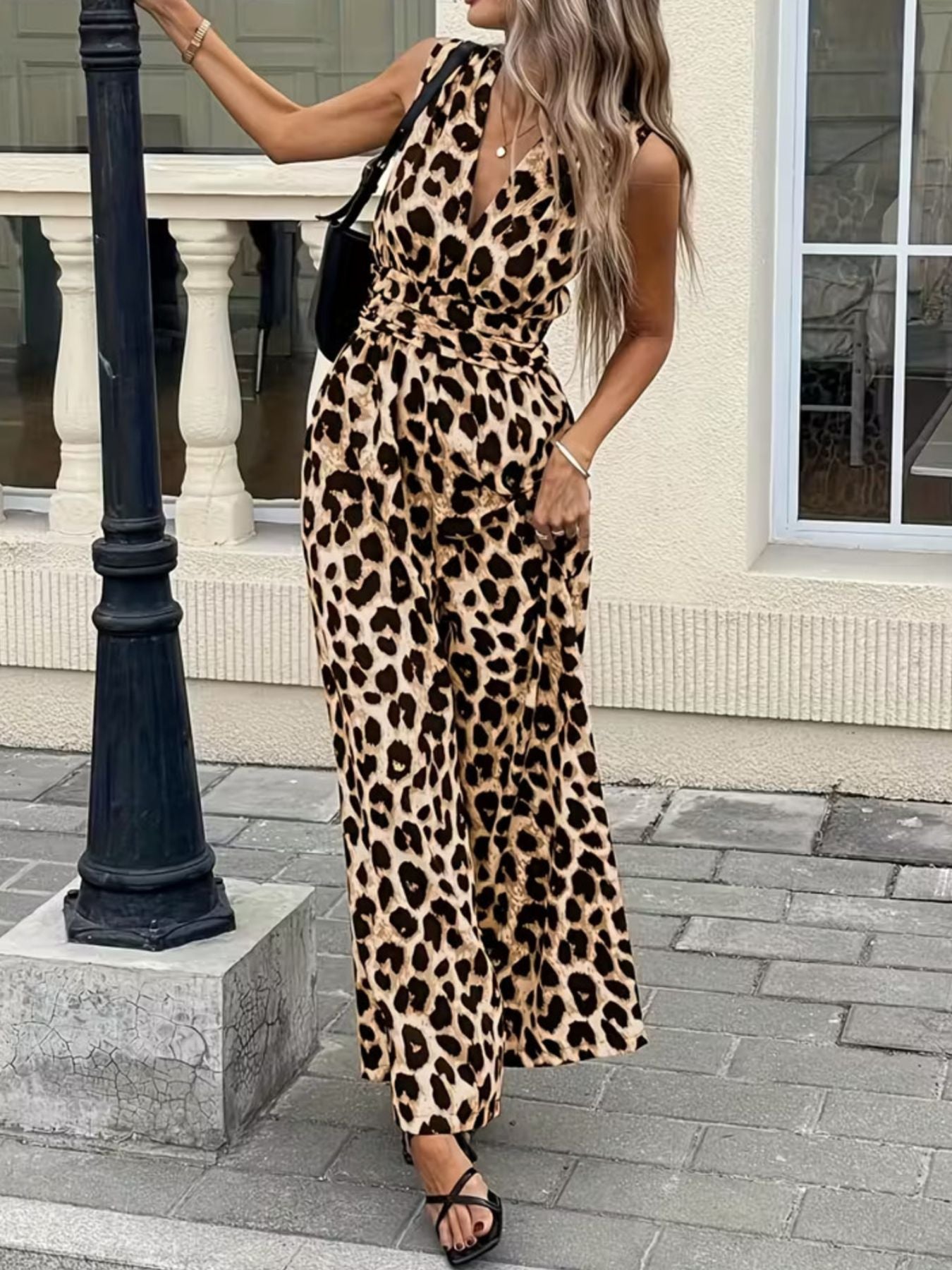 Chic sleeveless leopard print romper with V-neck and cinched waist.
