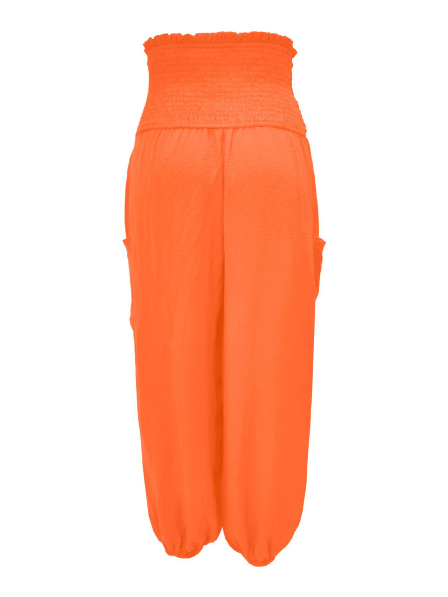 Orange smocked waist harem pants with pockets and ankle cuffs.