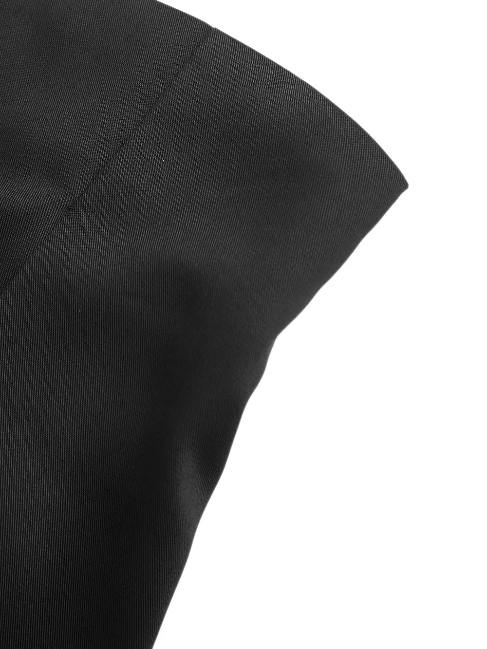 Black high-waisted pleated chino shorts with decorative button detail.