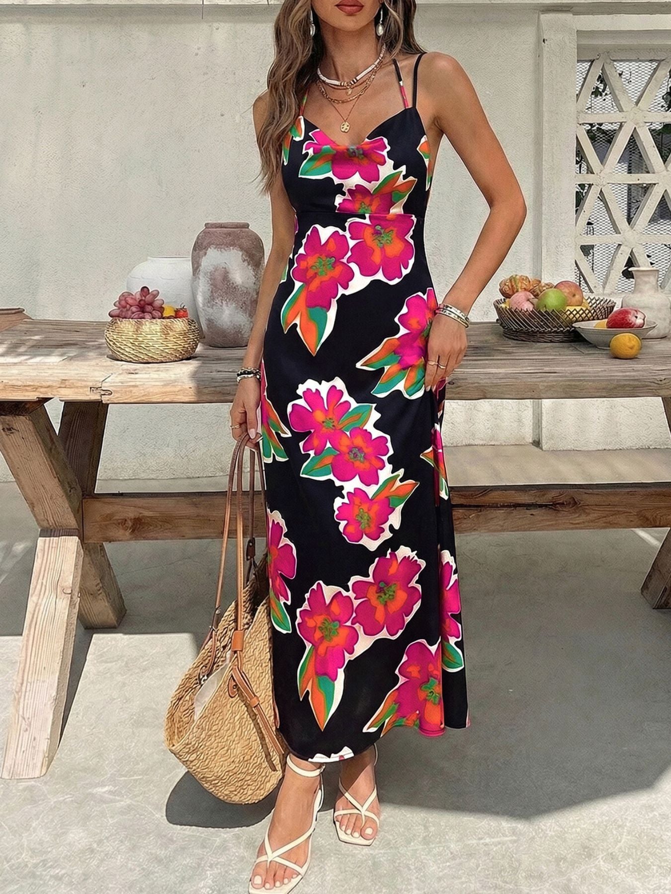 Vibrant floral midi dress with spaghetti straps in black with pink and orange flowers.