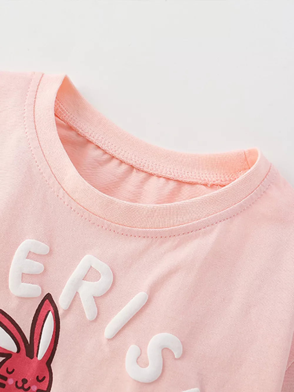 Blush pink cotton blend graphic tee with raised letters and a bunny graphic.