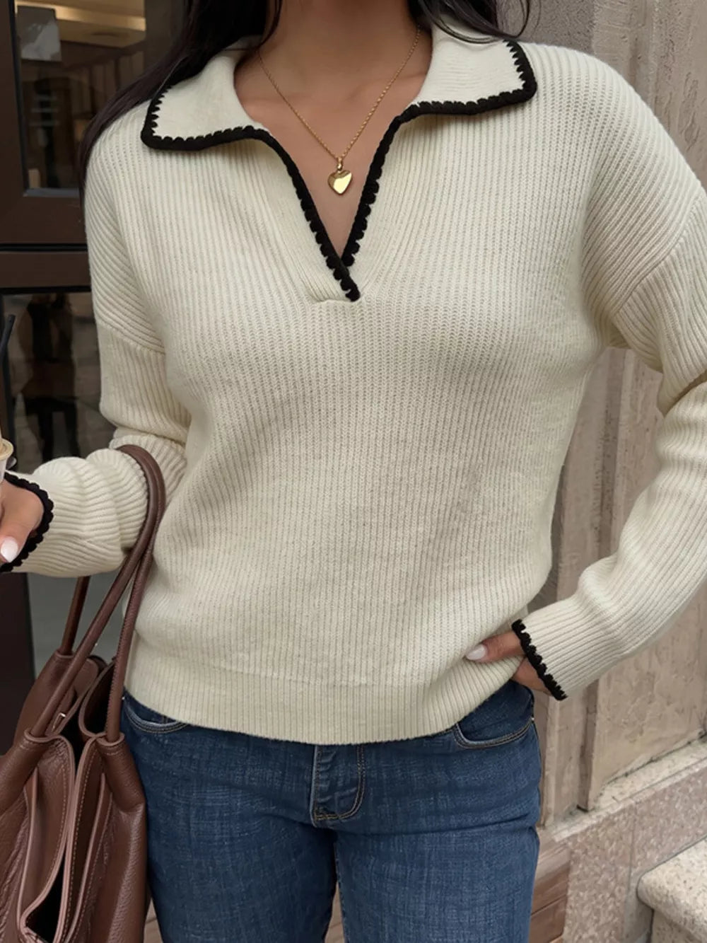 pullover sweater in cream featuring dropped shoulder and relaxed fit