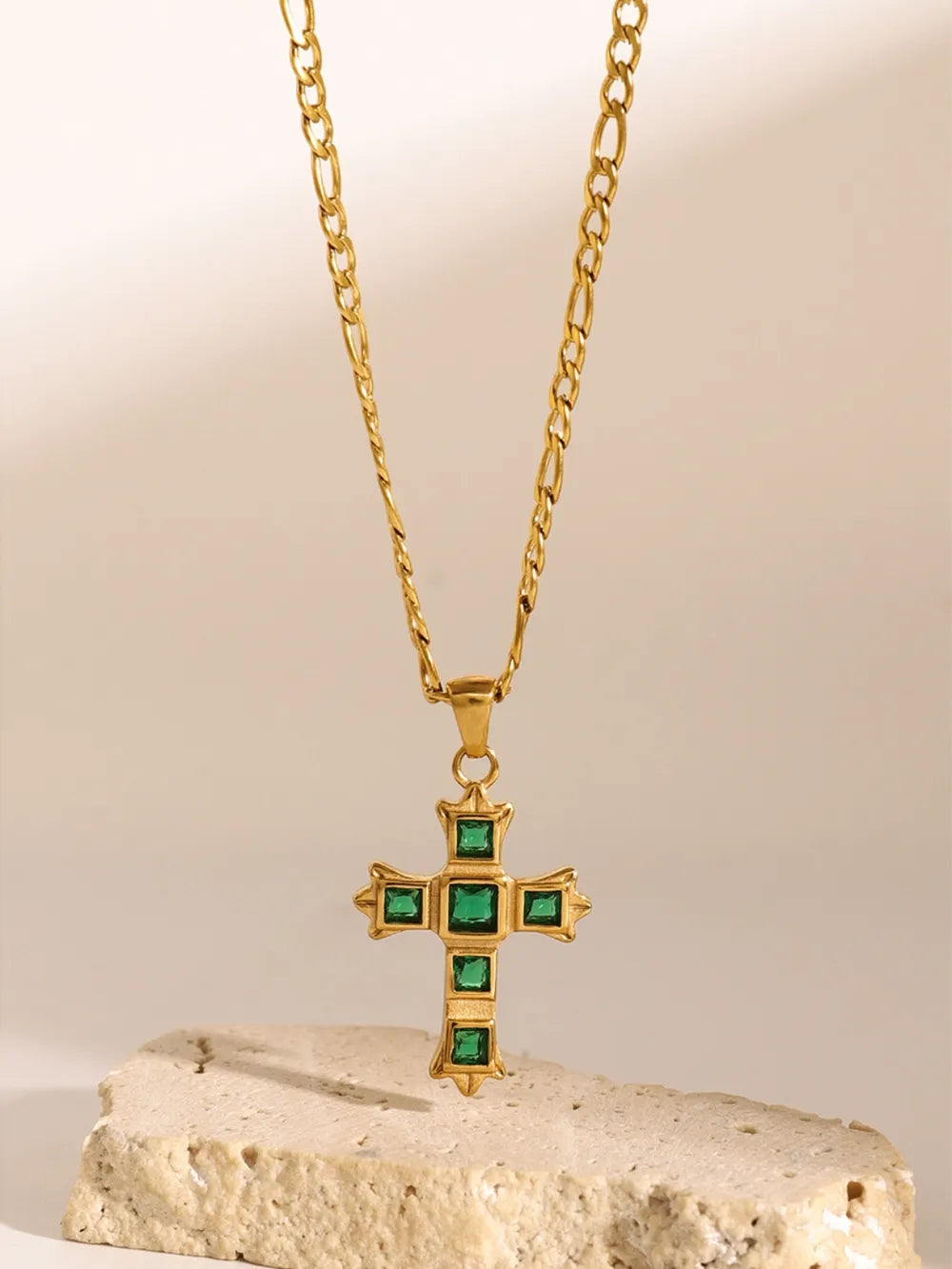 Gold cross pendant necklace with green zirconia stones