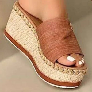 Textured platform slides in caramel with woven espadrille detail and metallic accent.