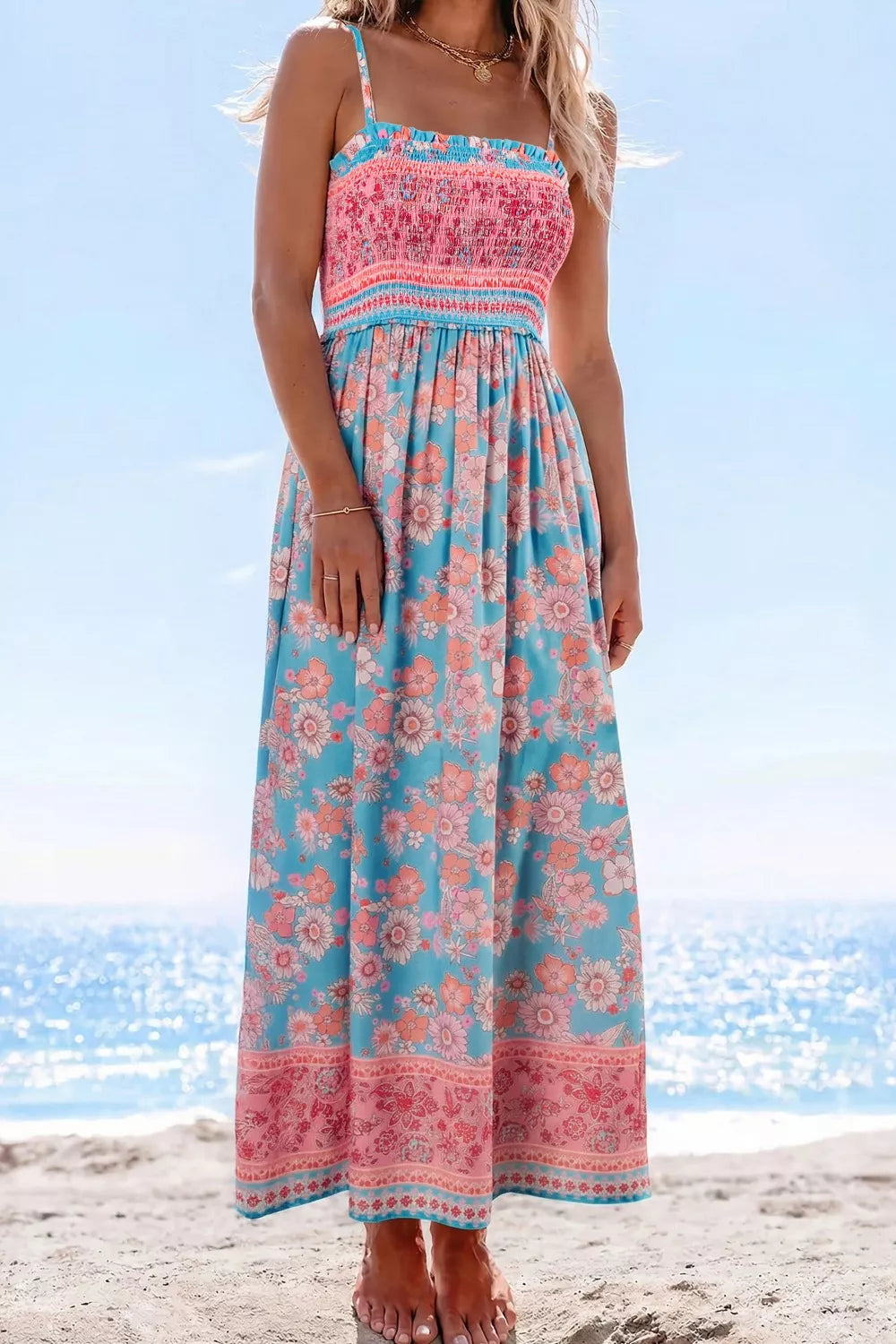 Bohemian floral maxi dress with smocked pink bodice and blue floral skirt.