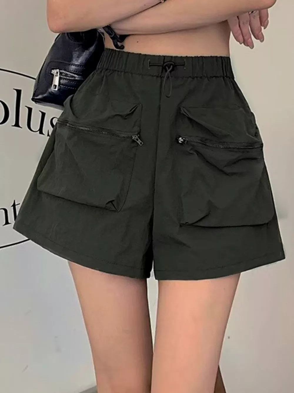 Army green cargo shorts with adjustable drawstring and zippered pockets