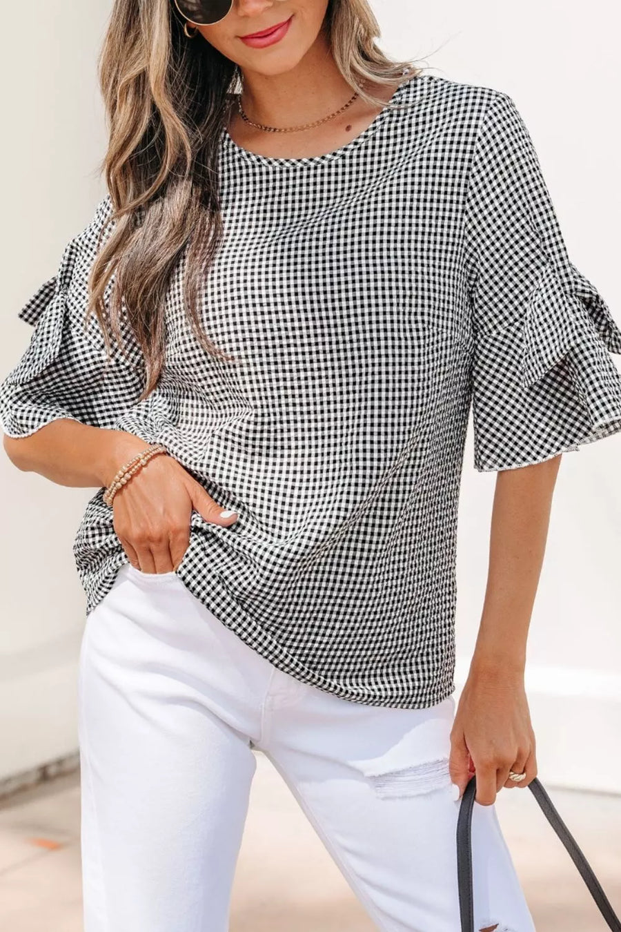 Gingham ruffled sleeve shirt in black and white polyester with a crew neck.