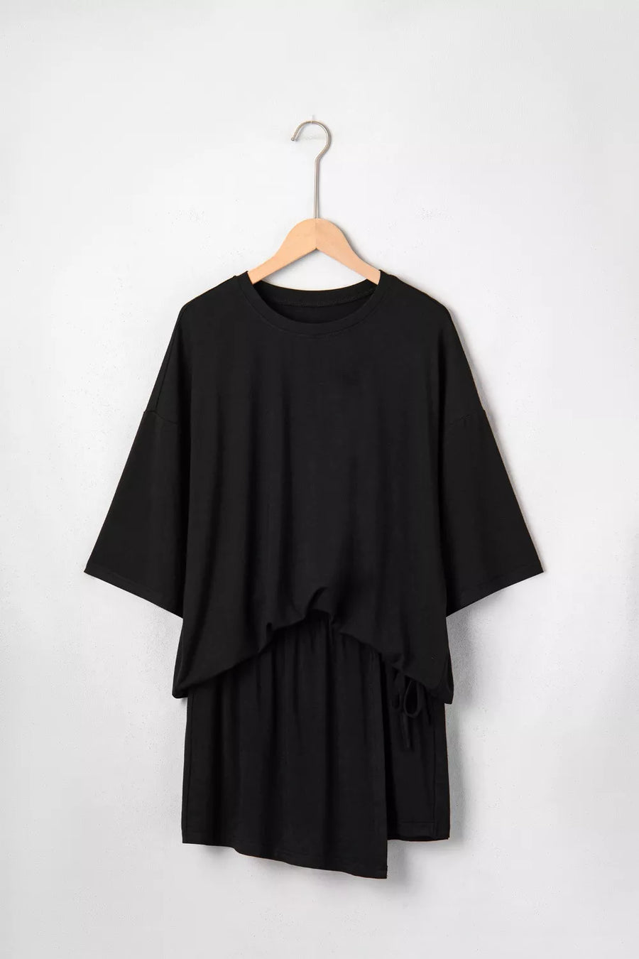 Black tie-wrap two-piece ensemble with asymmetric hem and drawstring detail