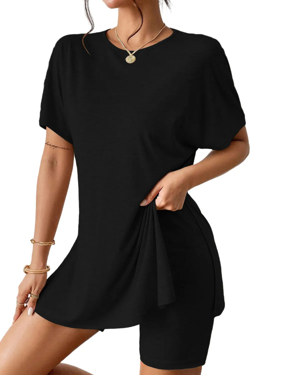Black drape front tee and shorts set with side slit detail.