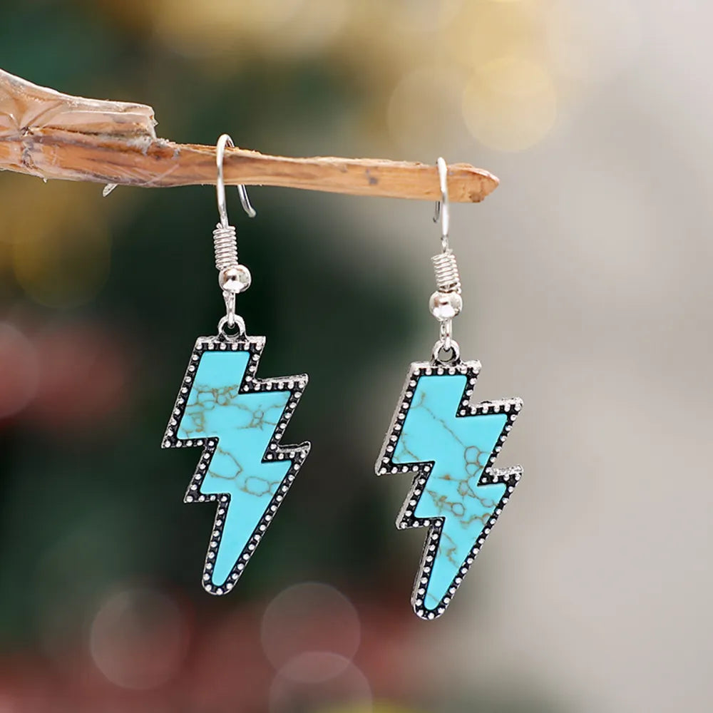 Turquoise bolt drop earrings with silver alloy setting and textured artificial turquoise inlay.