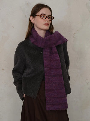 Textured mélange knit scarf in Deep Purple with subtle color variations, styled with a dark gray jacket.
