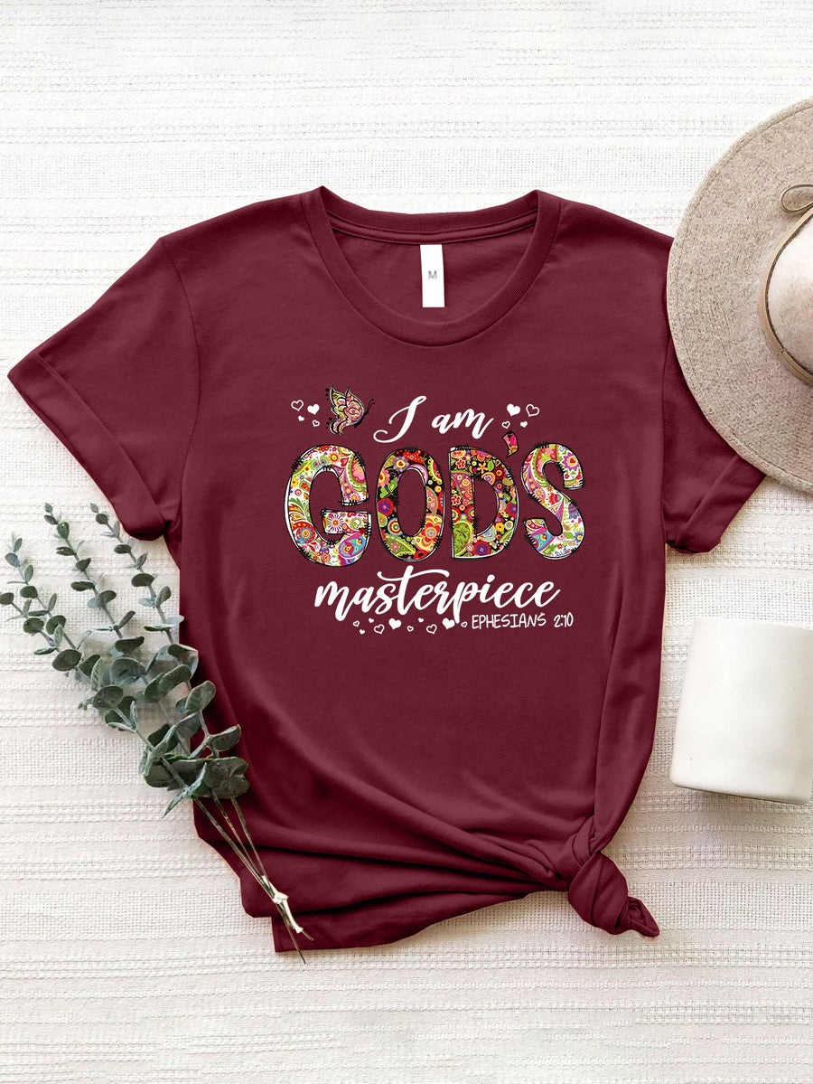 Burgundy graphic tee with floral typography reading "I am GOD'S masterpiece" and Ephesians 2:10.