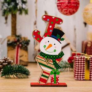 Festive wooden snowman decor with J letter, red stars, green scarf, and gift.