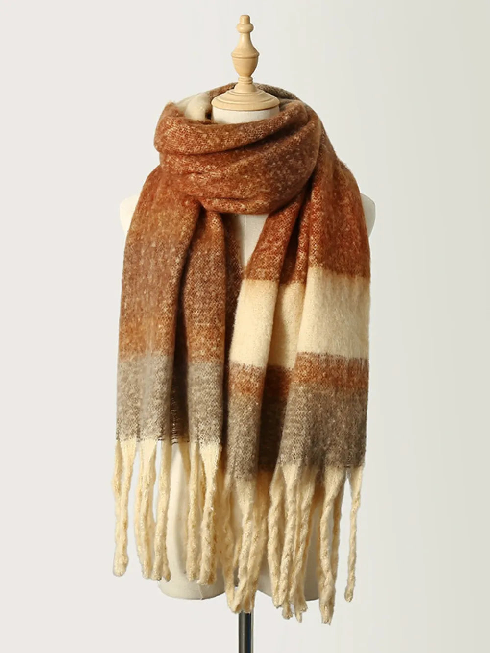 Ombre stripe tassel scarf in caramel with cream and brown blocks.