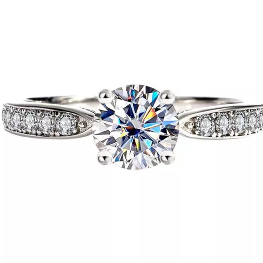 Elegant sterling silver ring with brilliant moissanite center stone and pave band.