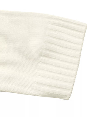 Cream knit sweater sleeve with ribbed cuff detail.