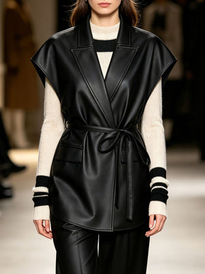 vest in black featuring belted and relaxed fit