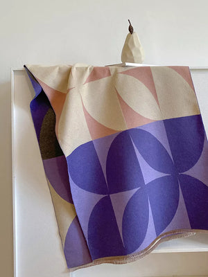 Geometric patterned soft scarf in purple and beige with fringes.