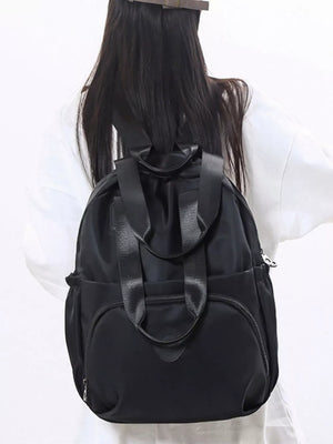 Black Oxford cloth backpack with adjustable straps and multiple pockets.