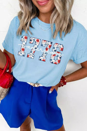 Light blue cotton t-shirt with floral 1776 graphic and short sleeves