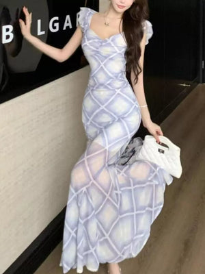 Ruched plaid bodycon maxi dress in blue with sweetheart neckline and short flutter sleeves.