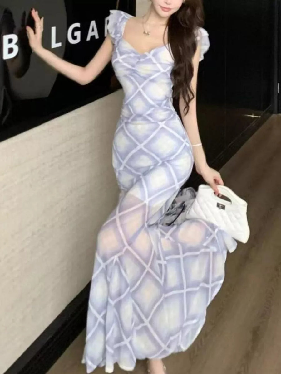 Ruched plaid bodycon maxi dress in blue with sweetheart neckline and short flutter sleeves.