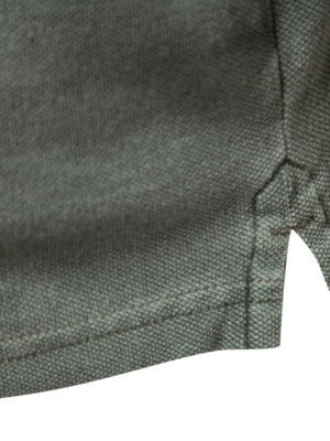 Textured polo shirt in dark gray with side vents and reinforced stitching.