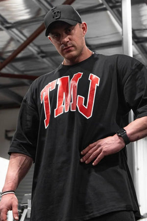Black oversized graphic tee with red TMJ logo and athletic appeal