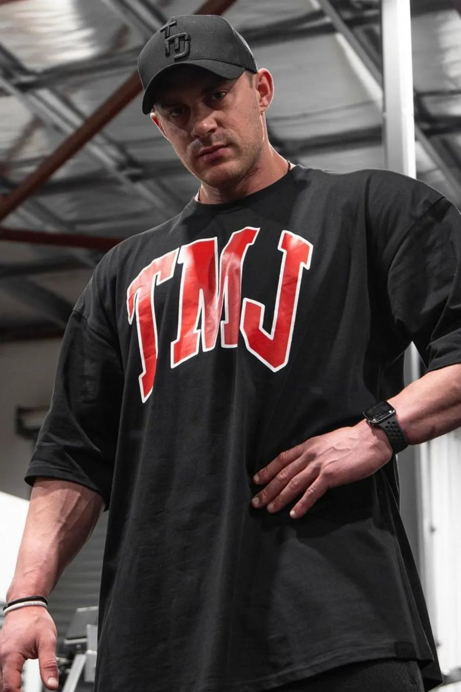 Black oversized graphic tee with red TMJ logo and athletic appeal