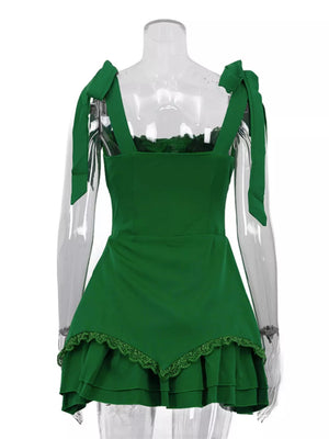 Green mini dress with tie shoulder straps, square neckline, and tiered lace hem.