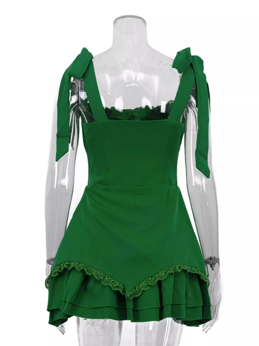 Green mini dress with tie shoulder straps, square neckline, and tiered lace hem.